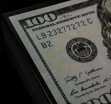 Close-up of the $100 bill artwork on the luxury backgammon case